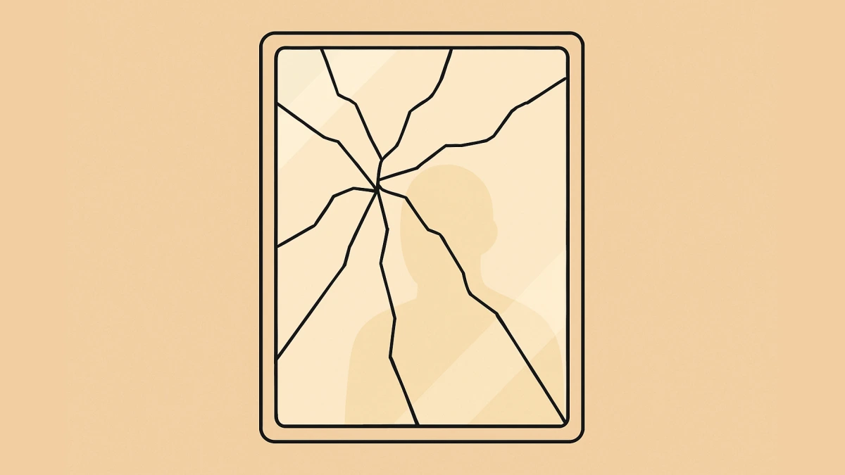 A cracked mirror with a silhouette in the reflection